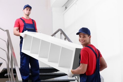 Professional removal team unloading items safely with protective gear