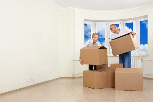 Same day removals crew carrying furniture through a Bromley property